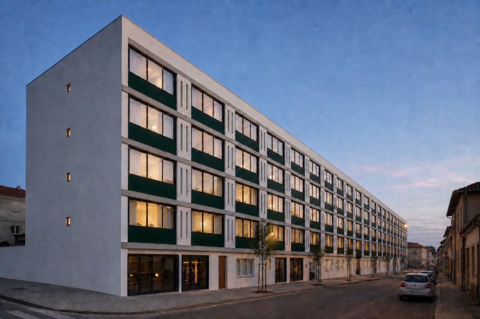 Street facade at dusk — white GRC panels, dark green louvres, warm windows